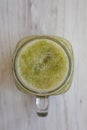 Homemade green cucumber apple smoothie in a glass jar, overhead view. Flat lay, top view, from above. Close-up Royalty Free Stock Photo