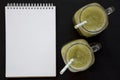 Homemade green cucumber apple smoothie in glass jars, blank notepad on a black background, top view. Flat lay, overhead, from Royalty Free Stock Photo