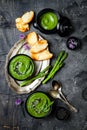 Homemade green spring asparagus cream soup decorated with black sesame seeds and edible chives flowers. Royalty Free Stock Photo