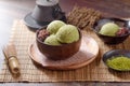 Homemade green tea or matcha ice cream in the wooden bowl and put on bamboo mat Royalty Free Stock Photo