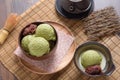 Homemade green tea or matcha ice cream in the wooden bowl and put on bamboo mat Royalty Free Stock Photo