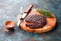 Homemade grilled beef burger or meat cutlet with Himalayan salt on a wooden board