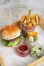 Homemade Grilled Plant Based Burger with salad, wedges and tomato sauce served in a serving board side view Royalty Free Stock Photo