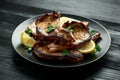 Homemade Grilled Pork loin chops in lemon sauce with herbs on rustic wooden table Royalty Free Stock Photo