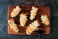 Halloween mummy jalapeno poppers on wooden server Royalty Free Stock Photo