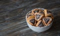 Homemade hamantashen cookies Haman`s ears with poppy seeds and apples on a wooden background. Traditional pastries for Purim,