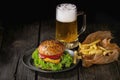 Homemade hamburger with beer and potatoes Royalty Free Stock Photo