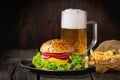 Homemade hamburger with beer and potatoes Royalty Free Stock Photo