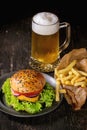 Homemade hamburger with beer and potatoes Royalty Free Stock Photo