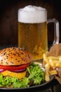 Homemade hamburger with beer and potatoes Royalty Free Stock Photo