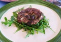 Homemade hamburger dish with rocket salad, narrow focus