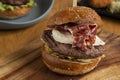 Homemade hamburger with straw potatoes, fried egg and Guijuelo ham on a wooden cutting board Royalty Free Stock Photo