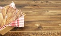 Homemade handmade tiny breads in basket on wooden background.