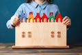 Homemade Happiness: A child& x27;s hands cradle a handcrafted house model, symbolizing family well-being and the joy of