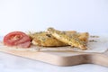 Homemade hard breads with a slice of a tomato on a baking paper in a kitchen, close up, macro Royalty Free Stock Photo