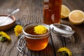 Homemade healthy dandelion syrup in a glass bottle, decorated with fresh flowers