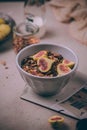 Homemade healthy granola with fresh figs and honey drizzle in a breakfast bowl on pink table Royalty Free Stock Photo