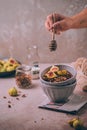 Homemade healthy granola with fresh figs and honey drizzle in a breakfast bowl on pink table Royalty Free Stock Photo