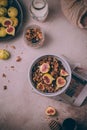 Homemade healthy granola with fresh figs and honey drizzle in a breakfast bowl on pink table Royalty Free Stock Photo