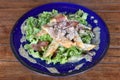 Homemade Healthy Green Goddess Salad with Chicken and Bacon with mix of crisp and sweet lettuce leaves on a plate on a table.