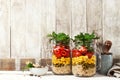 Homemade healthy layer salad in mason jars on a wooden background. Healthy life, food, detox concept Royalty Free Stock Photo