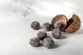 Homemade healthy protein energy balls in a coconut bowl with dried apricots, raisins, walnuts, almonds and coconut. Healthy sweet