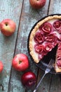 Homemade healthy sweets. Apple rose pie in cast iron pan on shabby blue background Royalty Free Stock Photo