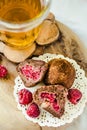 Homemade healthy vegan chocolate truffles with raspberry, dates, coconut flakes and rolled oats served on wooden plate.Close-up Royalty Free Stock Photo
