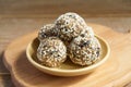 Homemade Healthy vegan Raw Energy Balls with sesame on wooden cuttng board