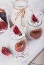 Homemade healthy yoghurt in glass jars with figs and chia seeds Royalty Free Stock Photo