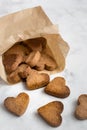 Homemade heart-shaped cookies in a craft bag, a Valentine`s Day gift with love, gluten-free buckwheat flour pastries Royalty Free Stock Photo