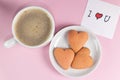 Homemade heart-shaped cookies, cup of coffee and a note with the words I love you on pastel pink color. Valentine's Day Royalty Free Stock Photo