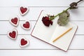 Homemade heart shaped cookies with empty notebook frame, pencil and red rose gift composition for Valentines Day Royalty Free Stock Photo