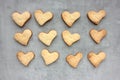 Homemade heart shaped cookies on a gray concrete background. Valentines day treats. Royalty Free Stock Photo