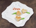 Homemade heart shaped toasts sandwiches with ham and cheese with ketchup letters Love on a plate Royalty Free Stock Photo