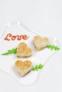 Homemade heart shaped toasts sandwiches with ketchup letters Love on a plate. Breakfast Concept, Top view Royalty Free Stock Photo