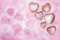 Homemade heart sheped donuts with powdered sugar on pnk background. Royalty Free Stock Photo