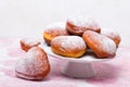Homemade heart sheped donuts with powdered sugar on pnk background. Royalty Free Stock Photo