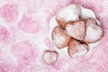 Homemade heart sheped donuts with powdered sugar on pnk background. Royalty Free Stock Photo