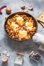 Homemade Hearty Breakfast Skillet with Eggs Potatoes and minced meat on concrete table Royalty Free Stock Photo