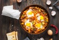 Homemade Hearty Breakfast Skillet with Eggs Potatoes and minced meat on wooden table Royalty Free Stock Photo