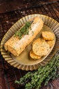 Homemade Herb Butter with thyme. Dark background. Top view