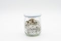 Homemade herbal salt in a glass jar for storage isolated on a white background