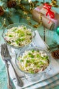 A homemade holiday snack Christmas table. Salad with squid, radish, sea cabbage, rice and egg Royalty Free Stock Photo