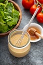 Homemade honey mustard dressing in a glass jar