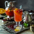 Homemade hot cranberry tea in glass cup on vintage silver tray Royalty Free Stock Photo