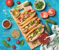 Homemade hot-dogs with fresh vegetables, spices, ketchup and mustard Royalty Free Stock Photo