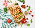 Homemade hot-dogs with fresh vegetables, spices, ketchup and mustard Royalty Free Stock Photo