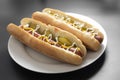 Homemade hot dogs with sausages and pickled cucubers in plate, isolated Royalty Free Stock Photo