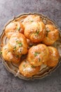 Homemade hot fresh Garlic Knots buns closeup on the plate. Vertical top view Royalty Free Stock Photo